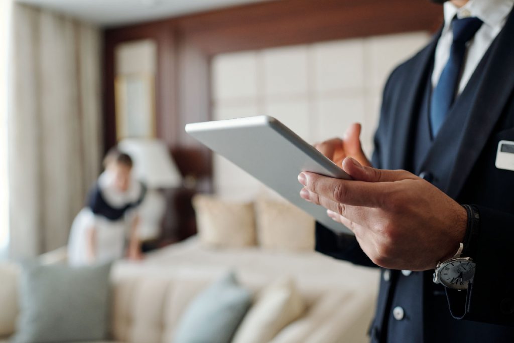 Housekeeping supervisor conducting room inspection on iPad