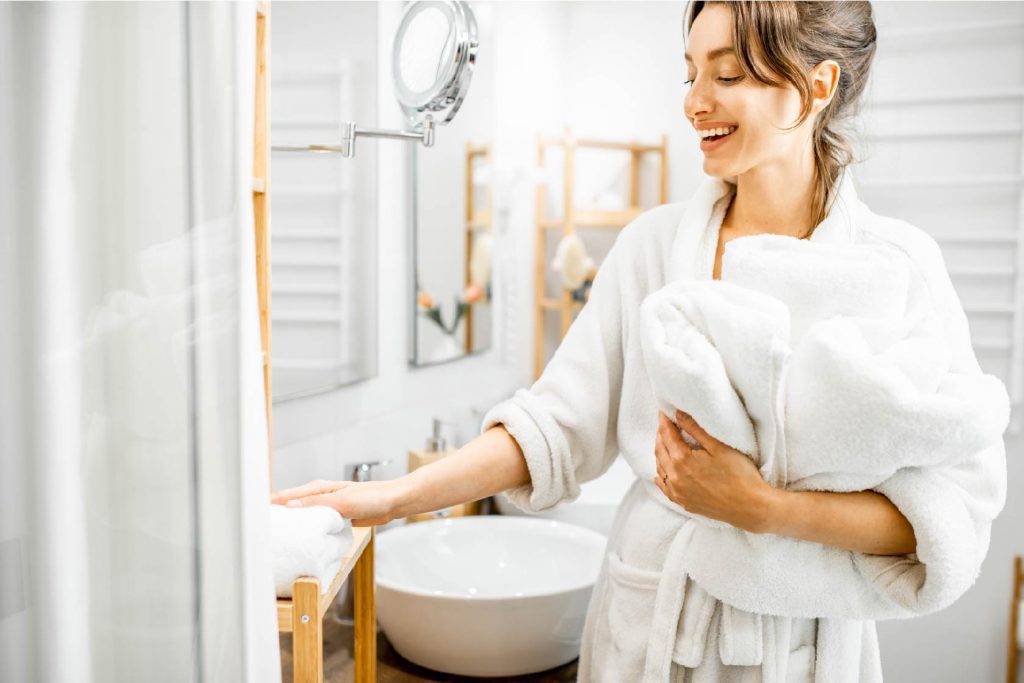 Happy guest with towels